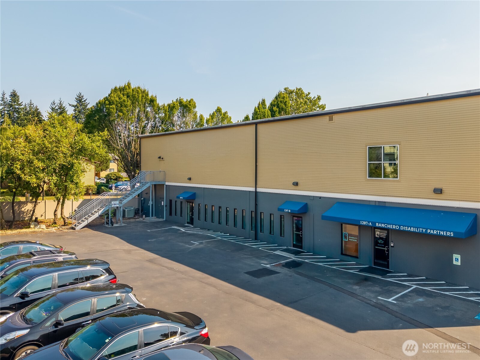 1207 North 152nd Street, Unit C Shoreline, WA 98133 - Photo 1 of 17 a view of a balcony with floor to ceiling windows and a table
