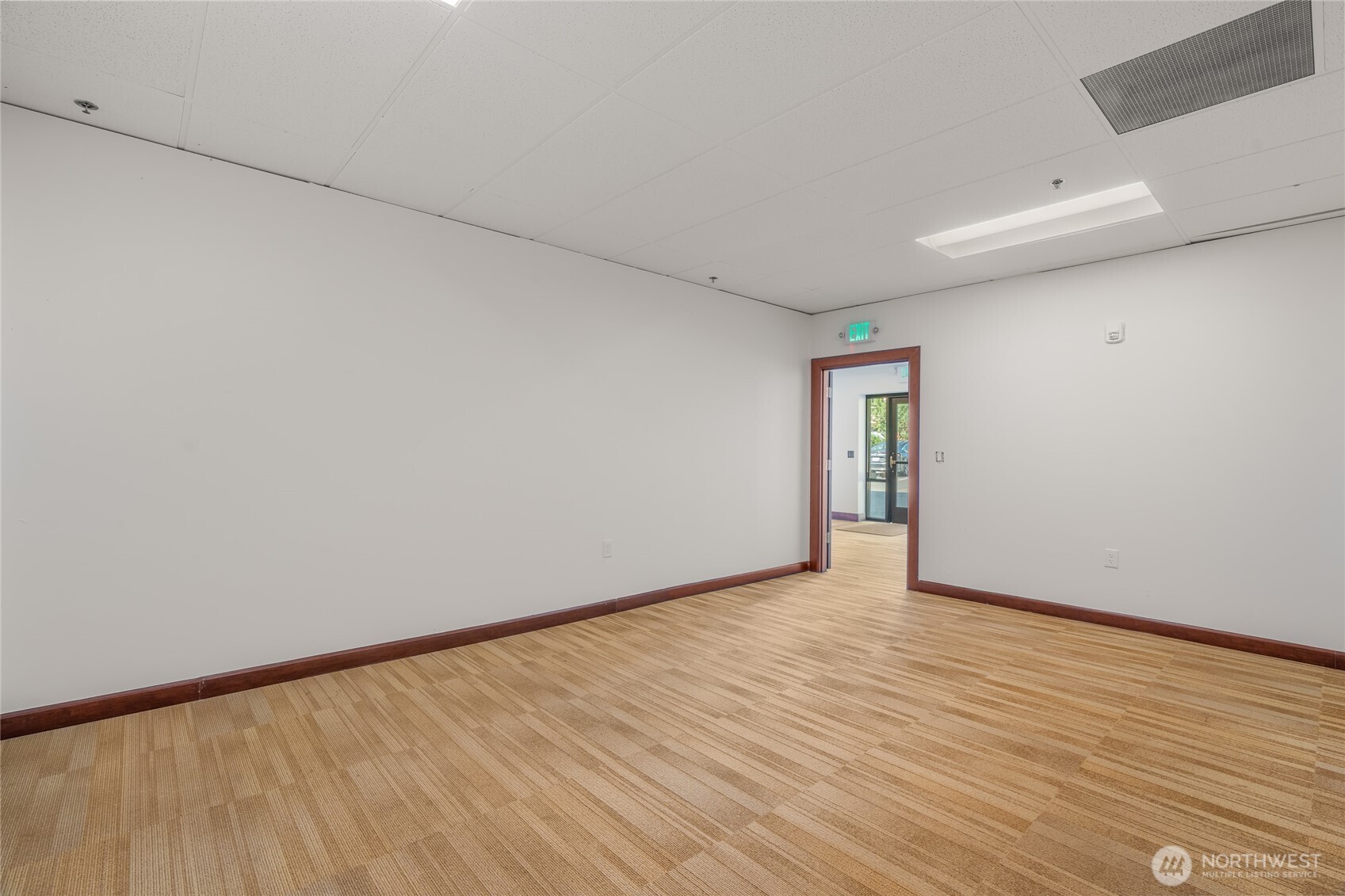 1207 North 152nd Street, Unit C Shoreline, WA 98133 - Photo 13 of 17 a view of an empty room with wooden floor and a window