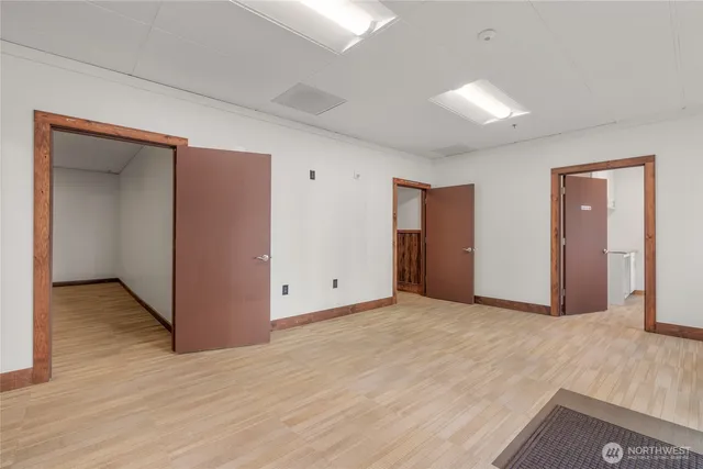 an empty room with wooden floor and closet