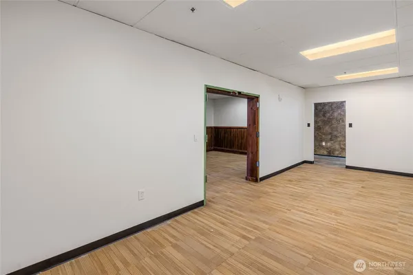 a view of an empty room with wooden floor