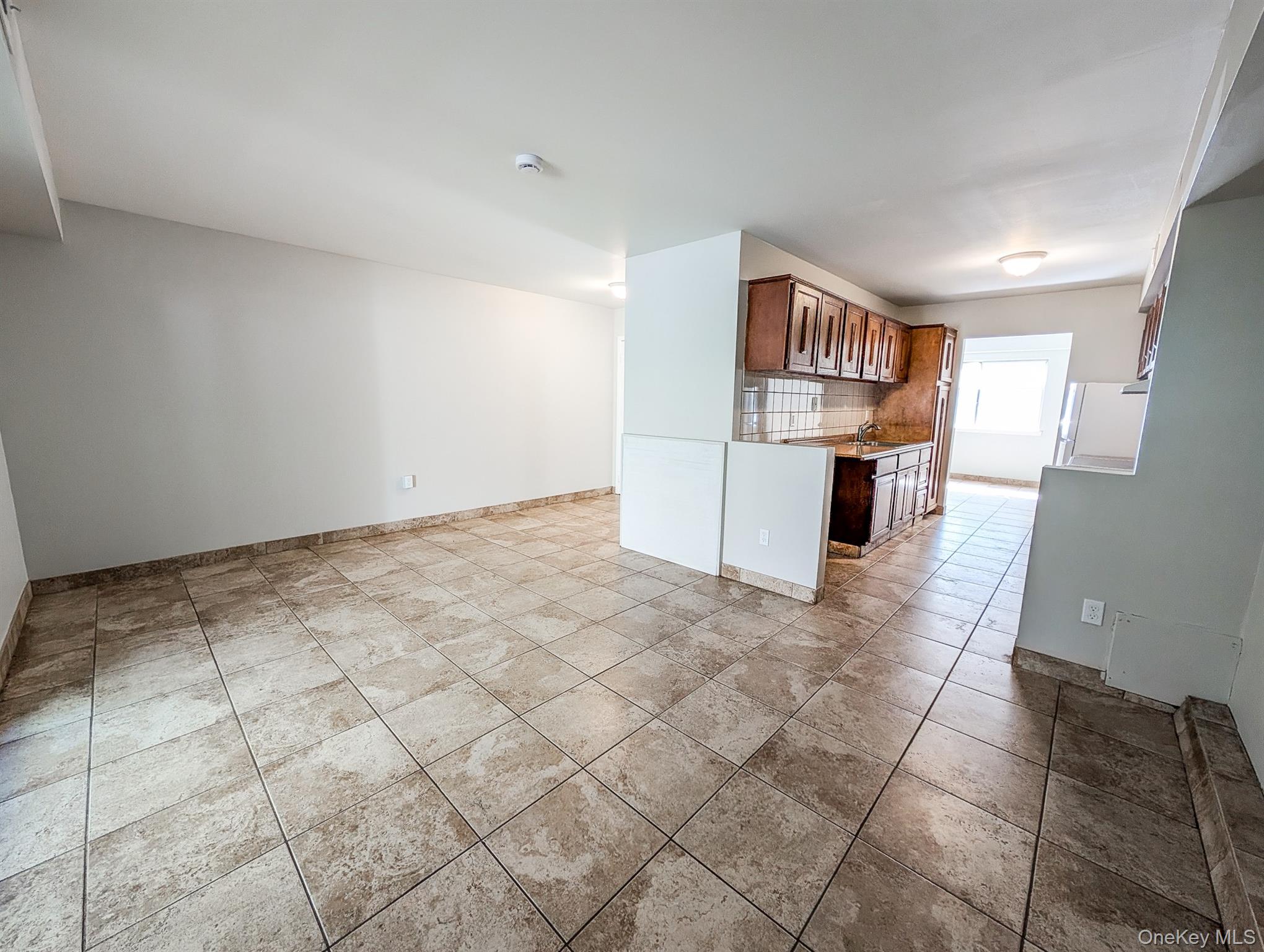 136 Hill Crescent Calverton, NY 11933 - Photo 7 of 21 Unfurnished living room featuring light tile patterned floors