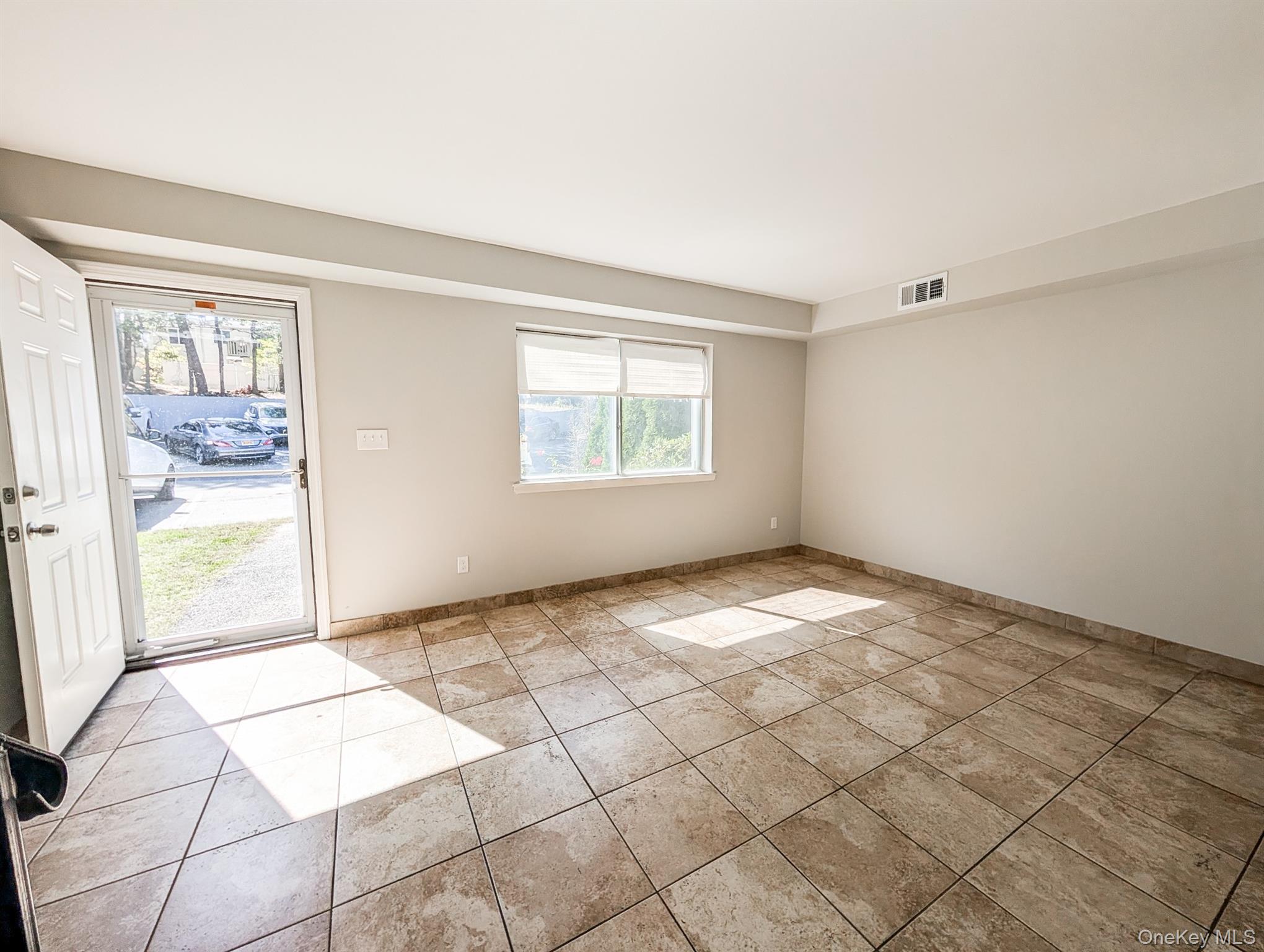 136 Hill Crescent Calverton, NY 11933 - Photo 8 of 21 Empty room with light tile patterned floors and baseboards