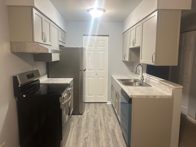 651 South Virginia Road, Unit 326 Crystal Lake, IL 60014 - Photo 2 of 9 a kitchen with a sink a refrigerator and cabinets