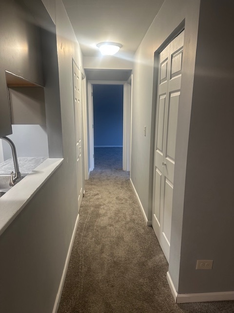 651 South Virginia Road, Unit 326 Crystal Lake, IL 60014 - Photo 7 of 9 a view of a hallway with granite countertop furniture