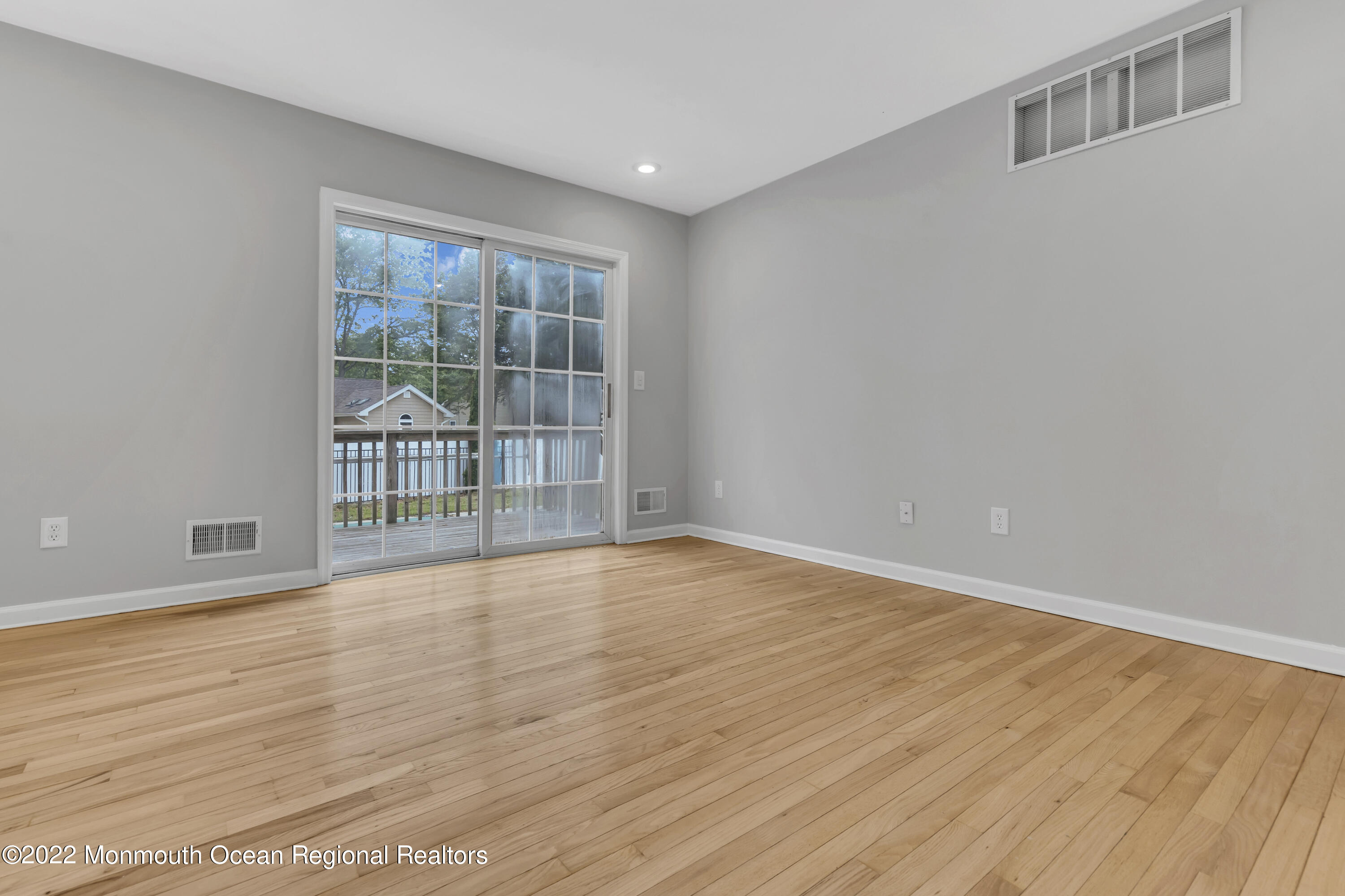 145 Gunwale Road Manahawkin, NJ 08050 - Photo 11 of 44 a view of an empty room with wooden floor and a window