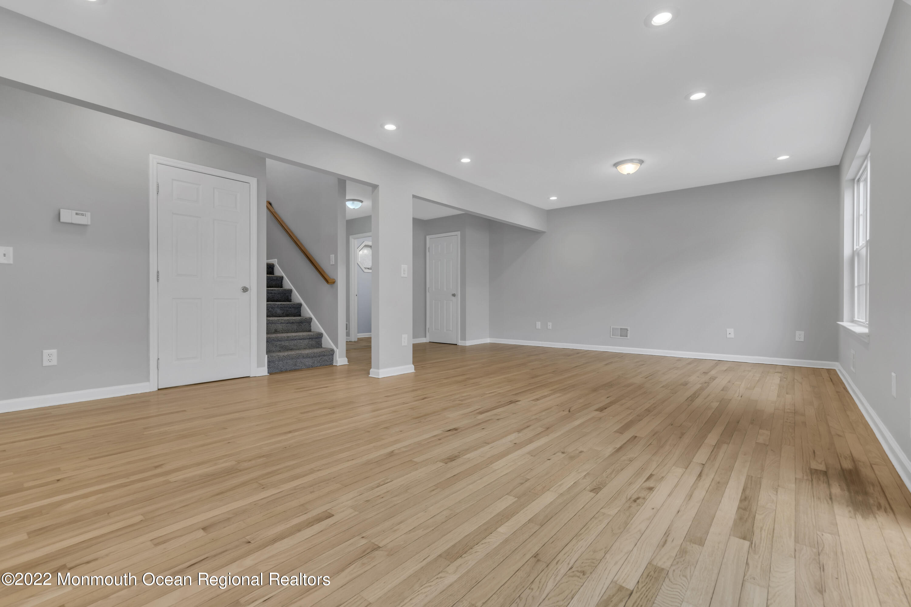 145 Gunwale Road Manahawkin, NJ 08050 - Photo 12 of 44 a view of an empty room with wooden floor and stairs