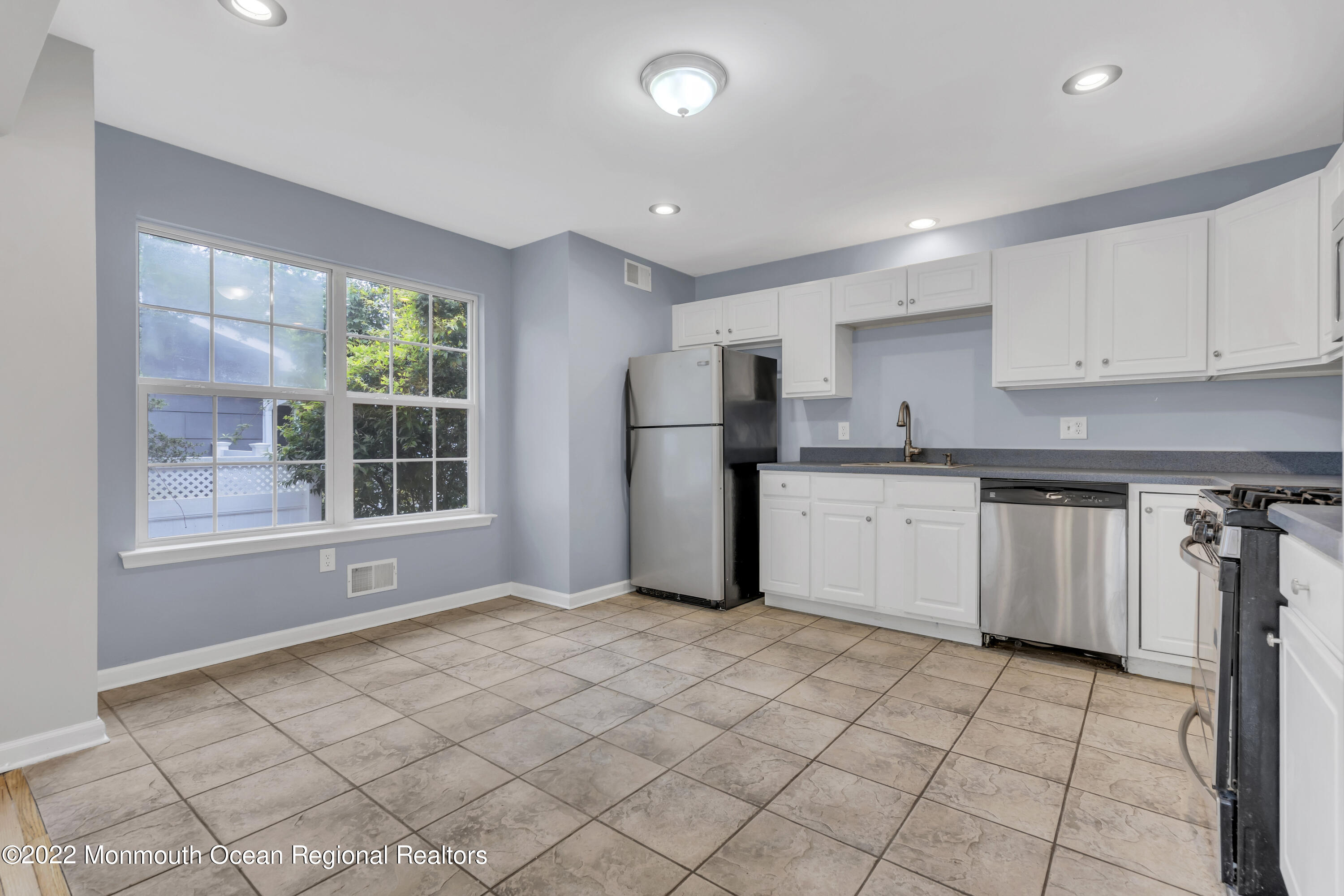 145 Gunwale Road Manahawkin, NJ 08050 - Photo 14 of 44 a kitchen with a refrigerator a stove top oven and white cabinets