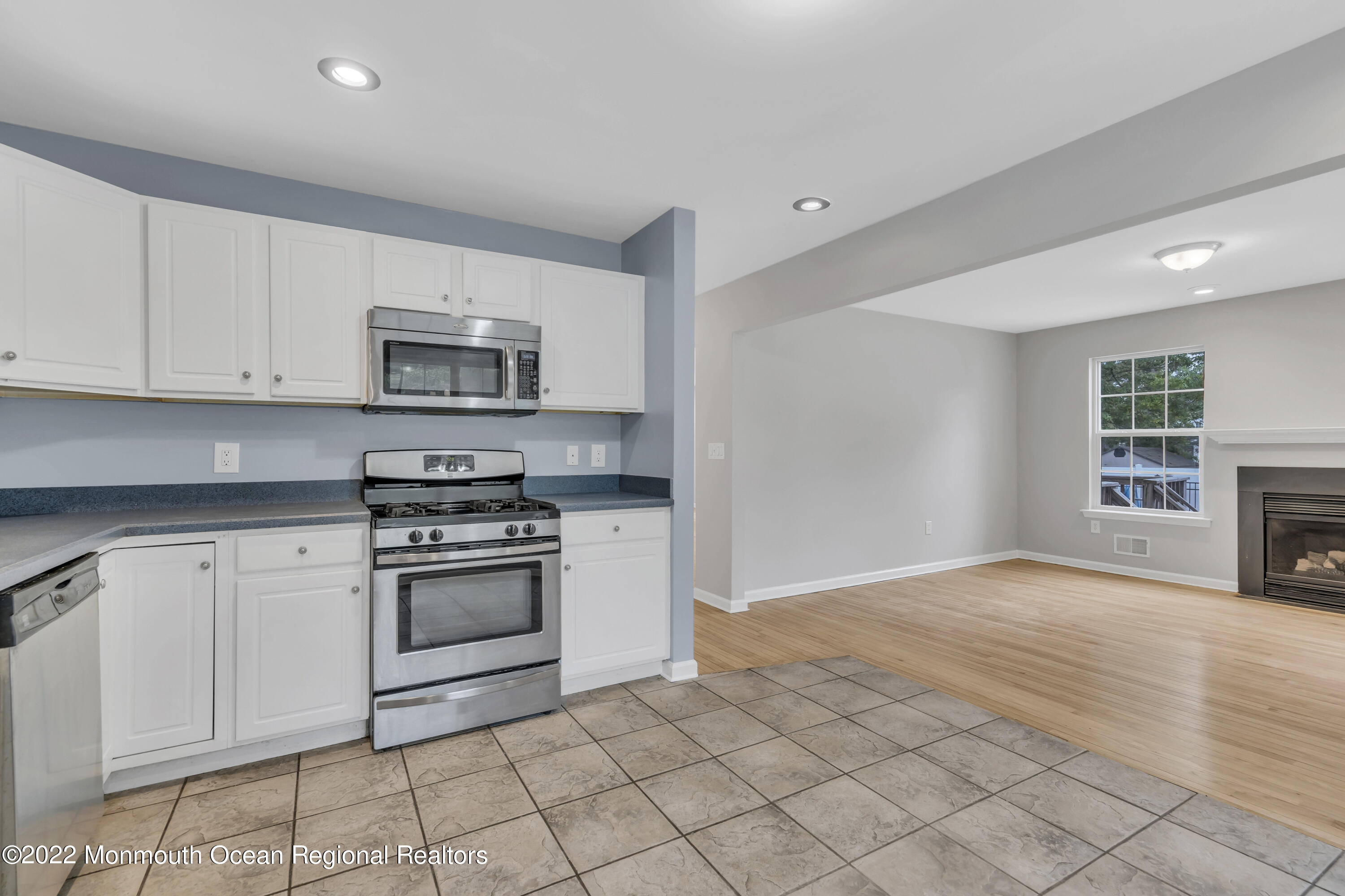 145 Gunwale Road Manahawkin, NJ 08050 - Photo 18 of 44 a kitchen with granite countertop a sink cabinets and stainless steel appliances