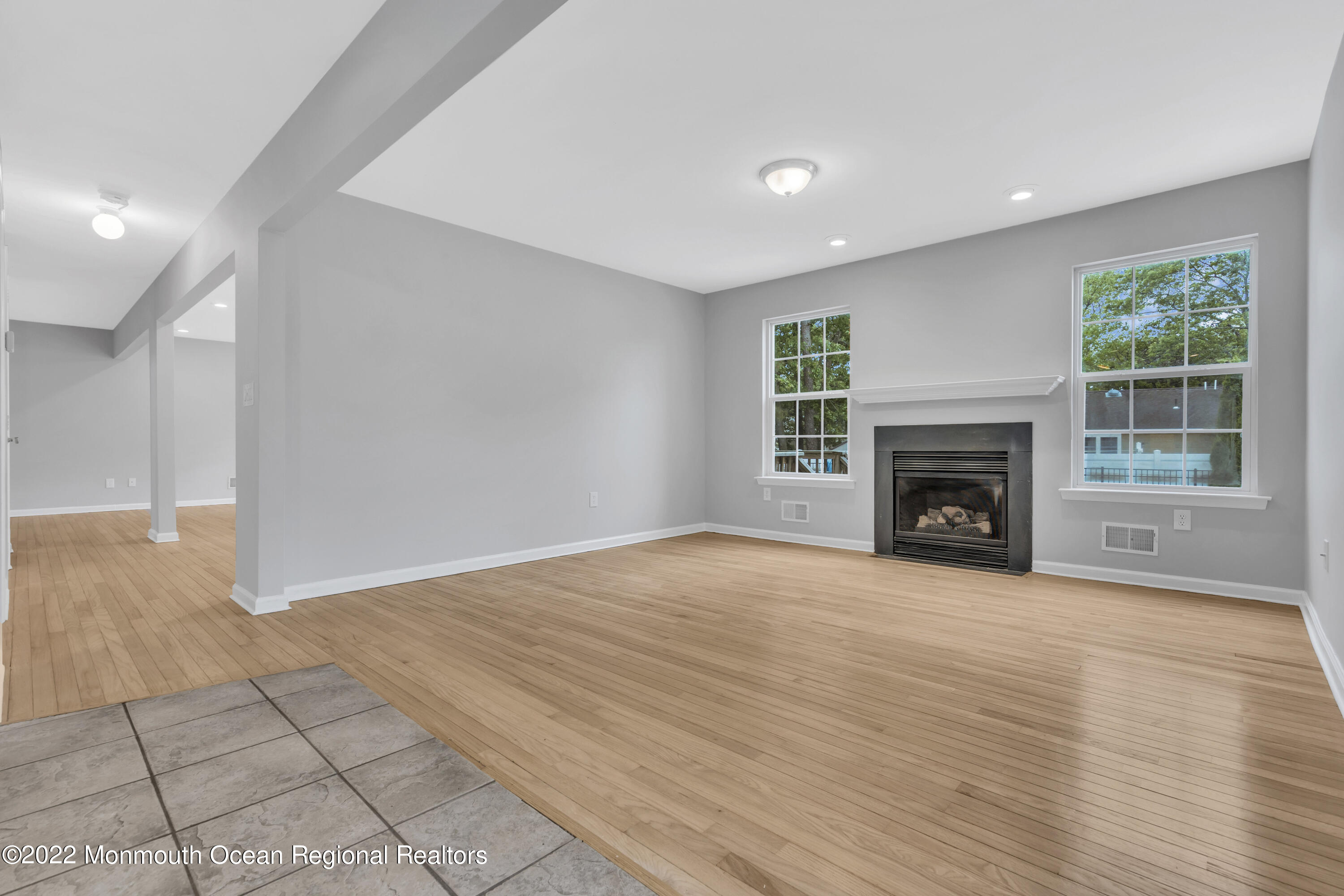 145 Gunwale Road Manahawkin, NJ 08050 - Photo 20 of 44 a view of empty room with wooden floor and fireplace