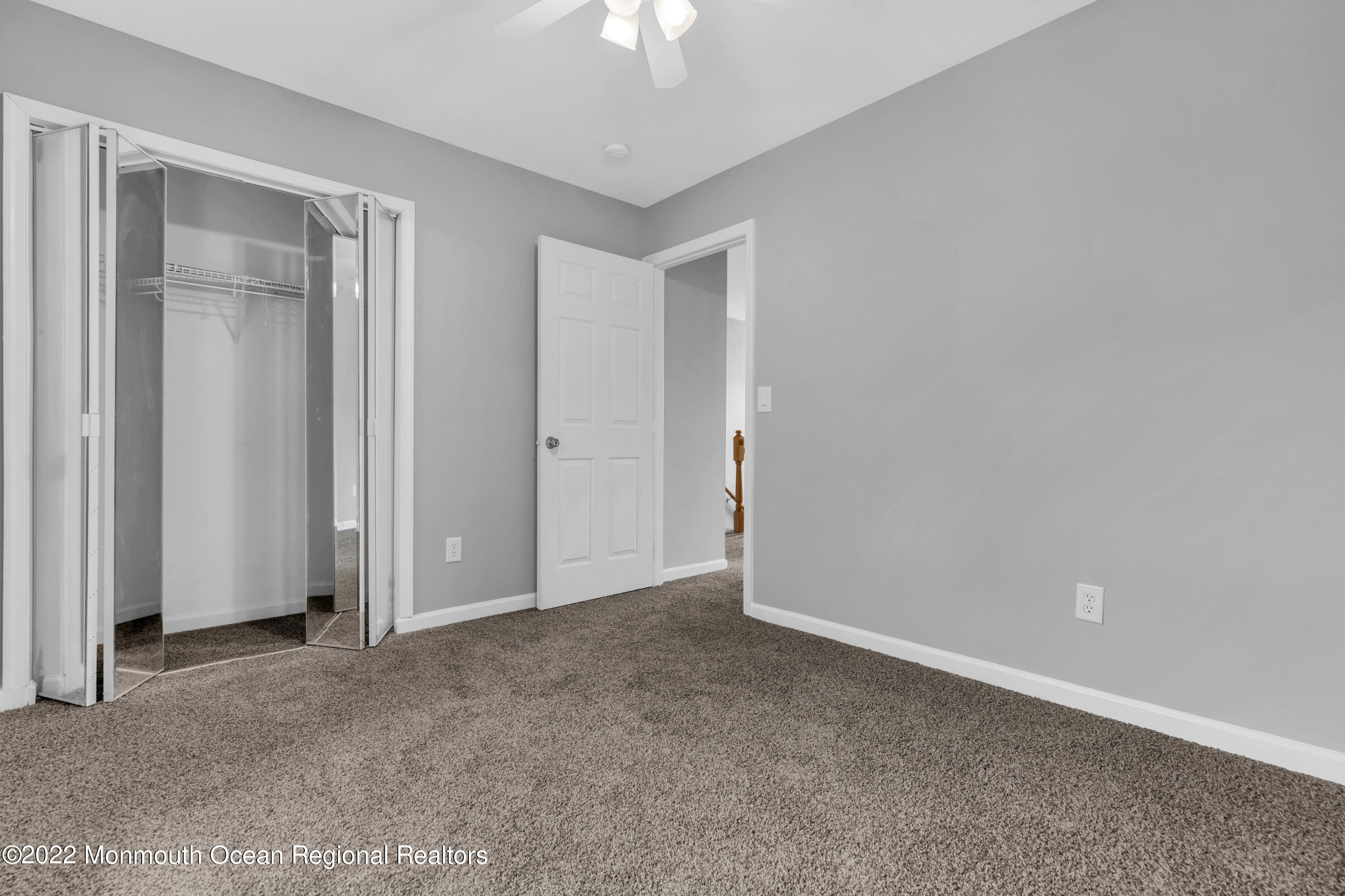 145 Gunwale Road Manahawkin, NJ 08050 - Photo 30 of 44 an empty room with a ceiling fan window and closet