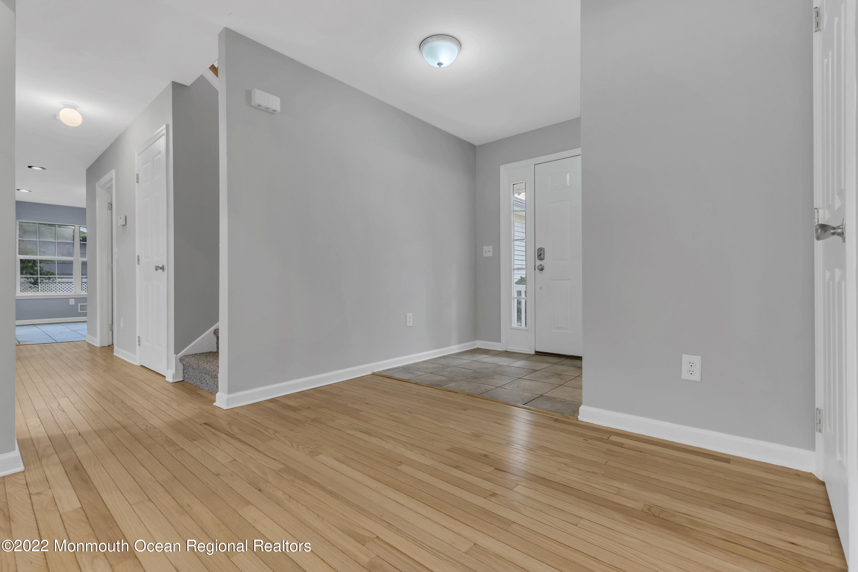 145 Gunwale Road Manahawkin, NJ 08050 - Photo 6 of 44 a view of an empty room with wooden floor and a bathroom