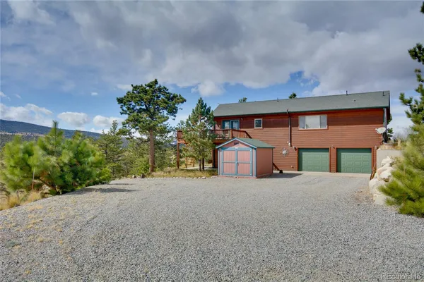 a front view of a house with a yard and a garage