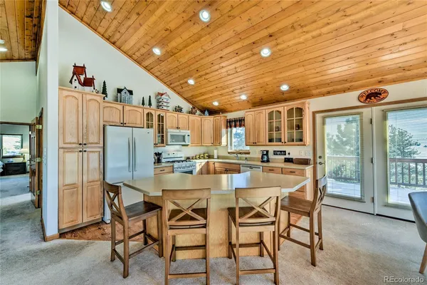 a kitchen with stainless steel appliances granite countertop a sink a stove and cabinets