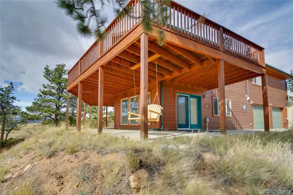 a view of a house with wooden deck