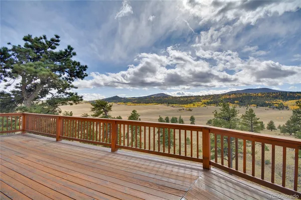 a view of balcony with wooden floor and fence