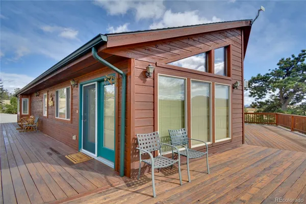 a view of porch with a floor to ceiling window next to a yard