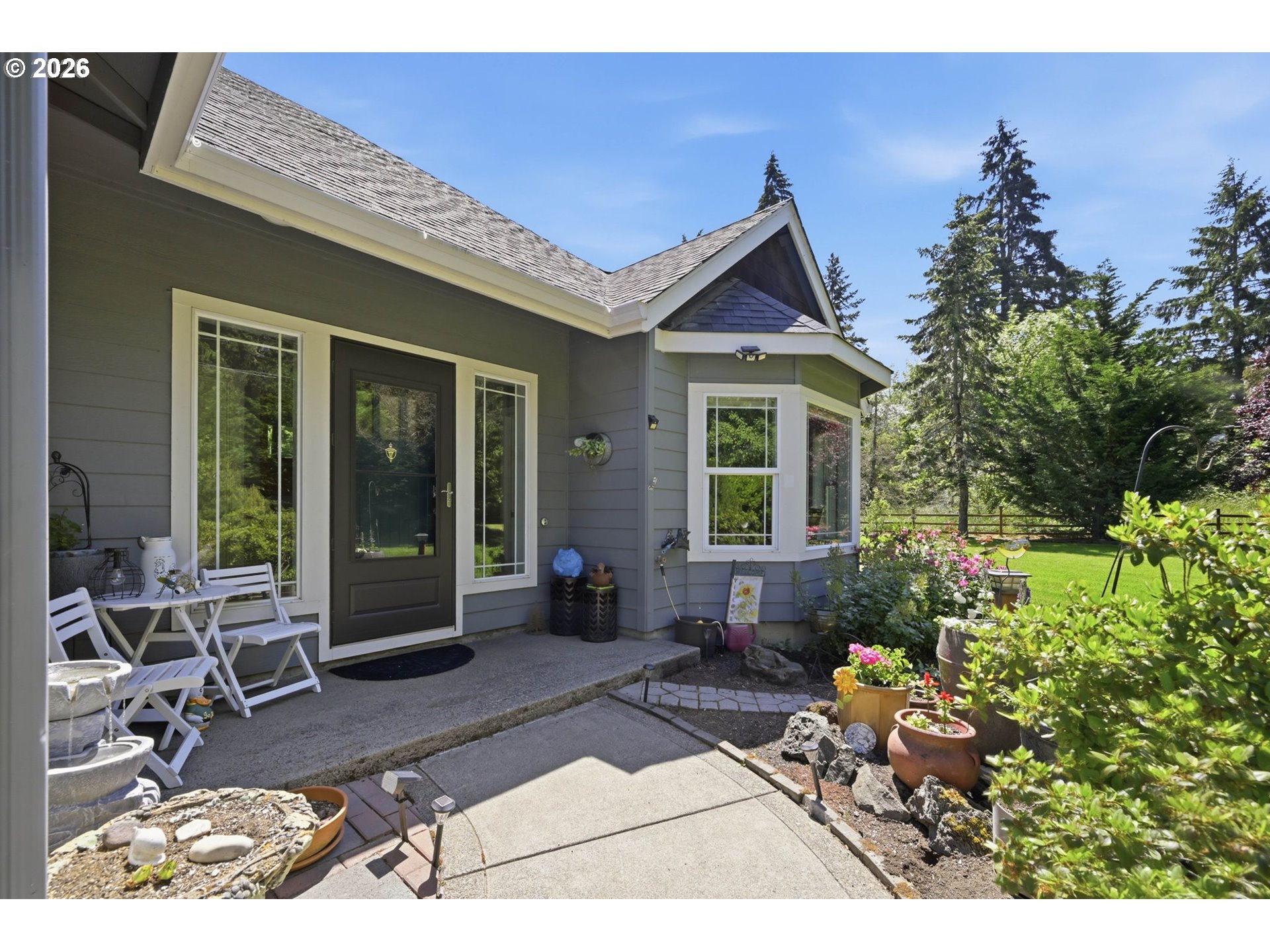 29778 Gimpl Hill Road Eugene, OR 97405 - Photo 39 of 43 a view of a house with backyard sitting area and garden