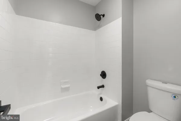 a bathroom with a bathtub and a toilet
