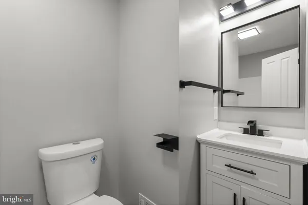 a bathroom with a sink a toilet and a mirror