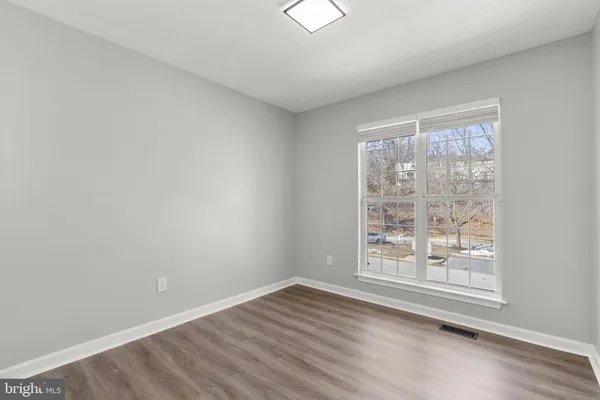 a view of wooden floor and windows in a room