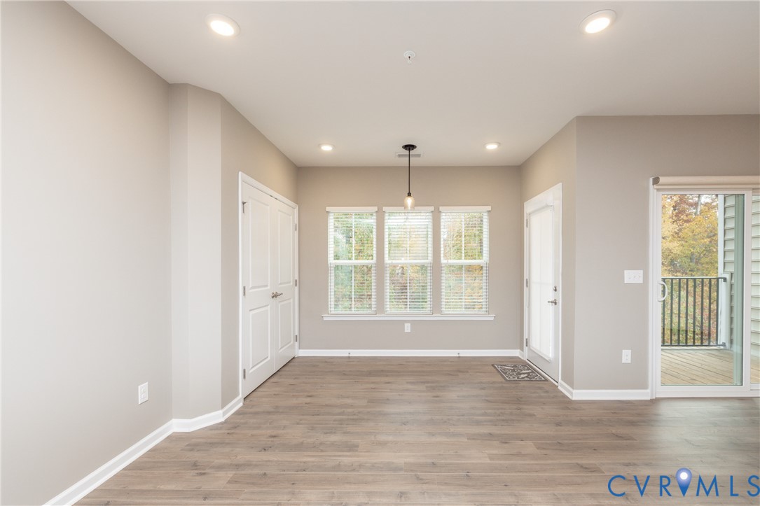 1111 Briars Court, Unit 303 Midlothian, VA 23114 - Photo 13 of 41 a view of an empty room with wooden floor and a window