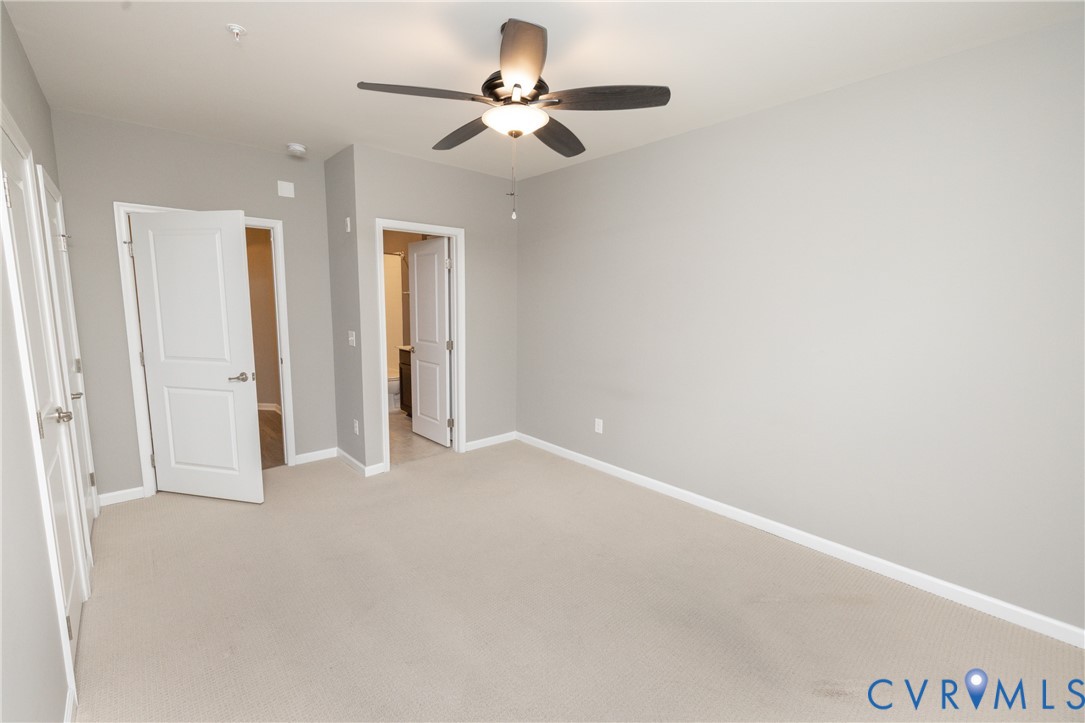 1111 Briars Court, Unit 303 Midlothian, VA 23114 - Photo 23 of 41 an empty room with closet and a chandelier fan