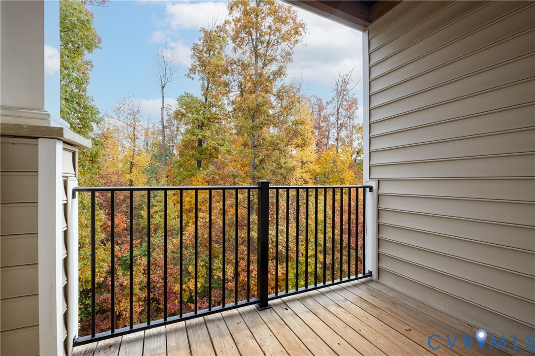 1111 Briars Court, Unit 303 Midlothian, VA 23114 - Photo 29 of 41 a balcony with wooden floor and fence