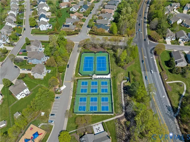 an aerial view of residential houses with outdoor space and street view