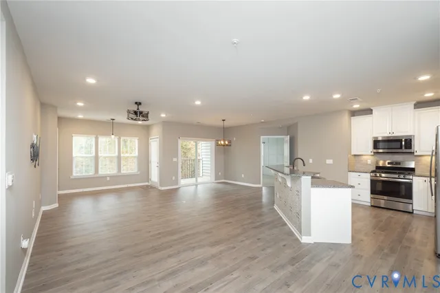 a view of kitchen with sink and wooden floor