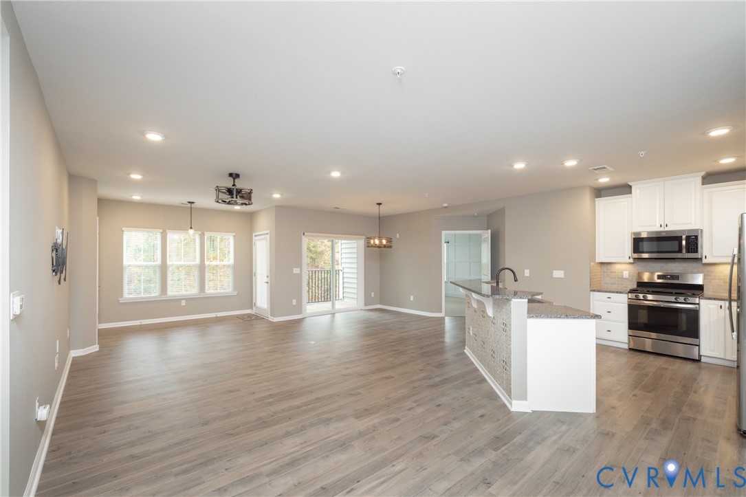 1111 Briars Court, Unit 303 Midlothian, VA 23114 - Photo 4 of 41 a view of kitchen with sink and wooden floor