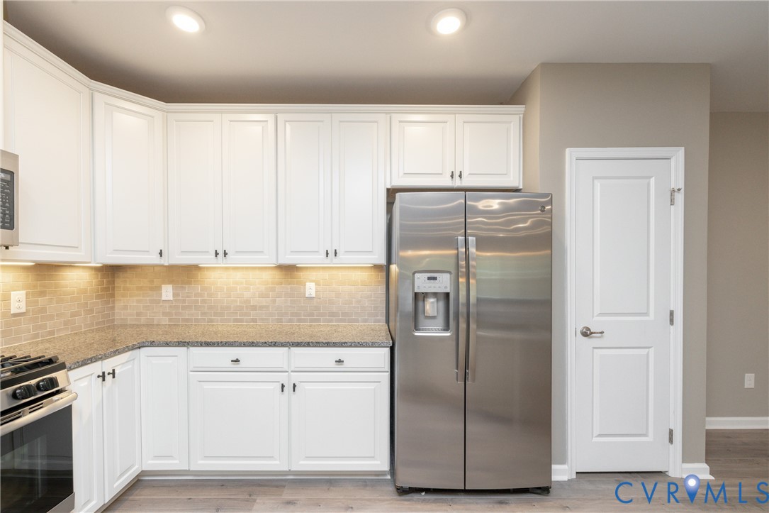1111 Briars Court, Unit 303 Midlothian, VA 23114 - Photo 7 of 41 a kitchen with refrigerator a stove and cabinets