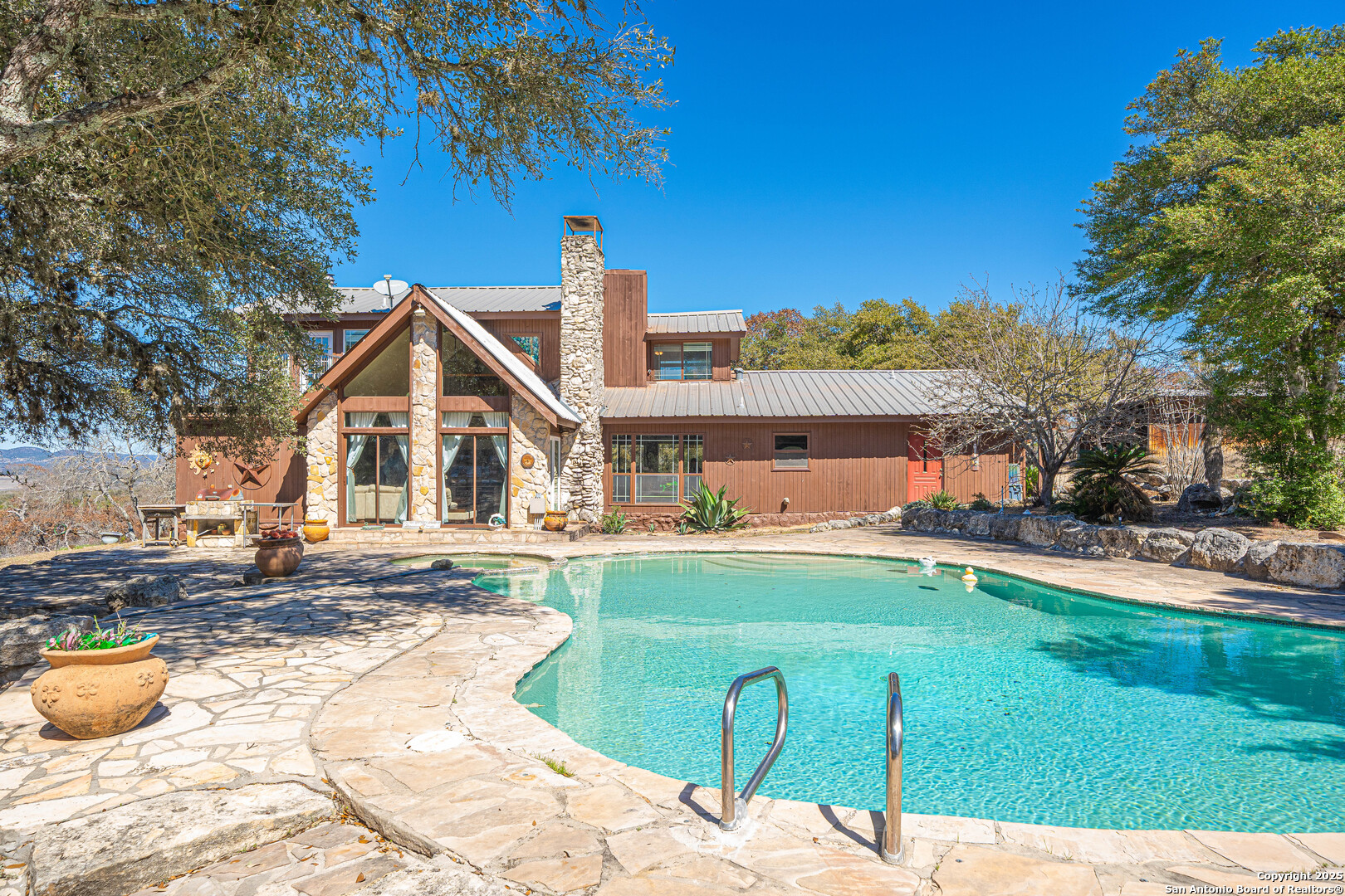 1839 Thanksgiving Road Utopia, TX 78884 - Photo 13 of 96 a view of a house with a swimming pool