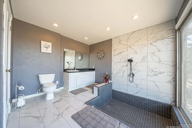 an aerial view of a house with a yard basket ball court and outdoor seating