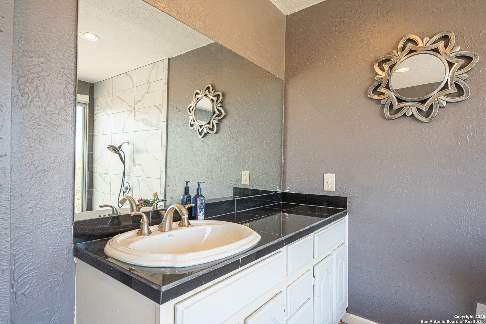 1839 Thanksgiving Road Utopia, TX 78884 - Photo 37 of 96 a bathroom with a sink and a mirror