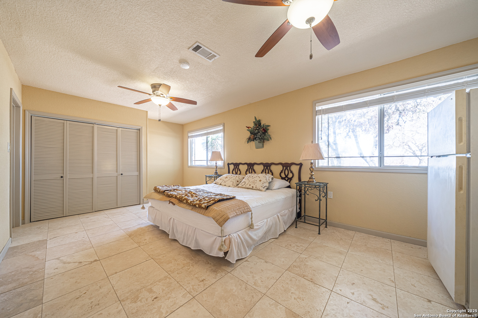 1839 Thanksgiving Road Utopia, TX 78884 - Photo 40 of 96 a spacious bedroom with a bed and ceiling fan