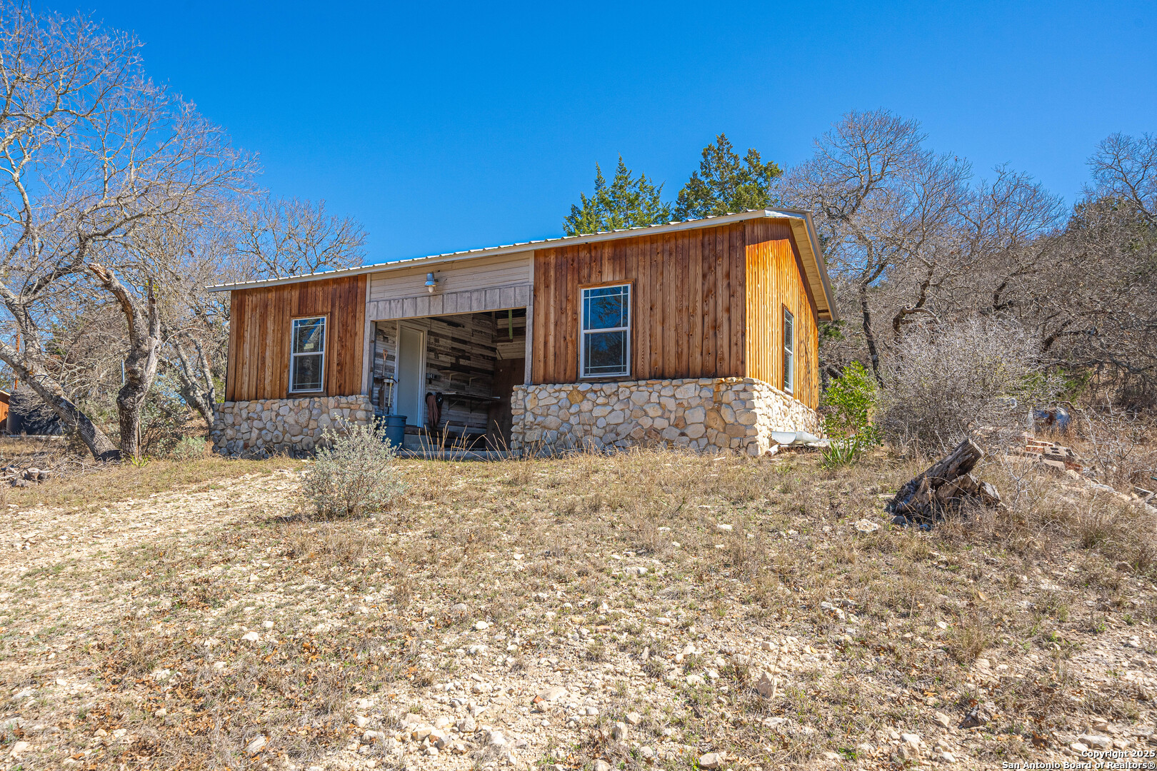 1839 Thanksgiving Road Utopia, TX 78884 - Photo 63 of 96 a front view of house with yard and trees in the background