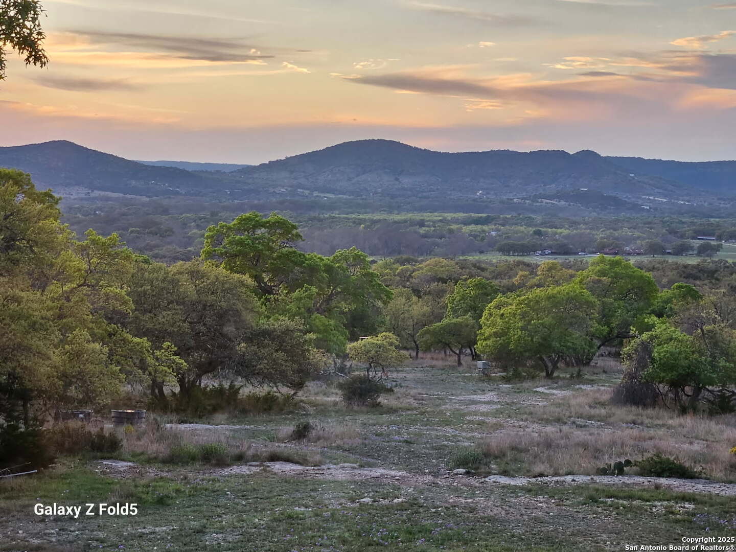 1839 Thanksgiving Road Utopia, TX 78884 - Photo 91 of 96 a view of a lush green hillside and a houses