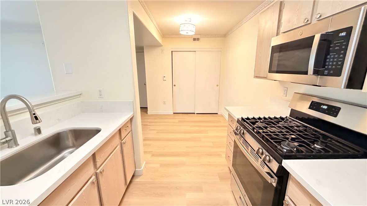 7885 West Flamingo Road, Unit 1131 Las Vegas, NV 89147 - Photo 21 of 36 Modern kitchen with sleek stainless steel appliances and ample counter space for culinary creations.