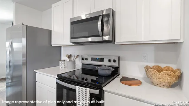 a kitchen with stainless steel appliances granite countertop a stove and a microwave