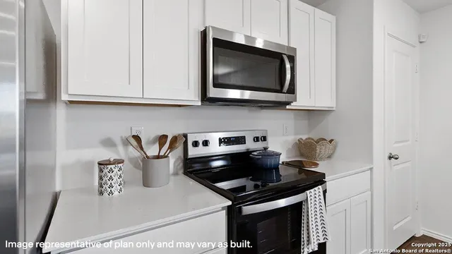 a kitchen with a stove and a microwave
