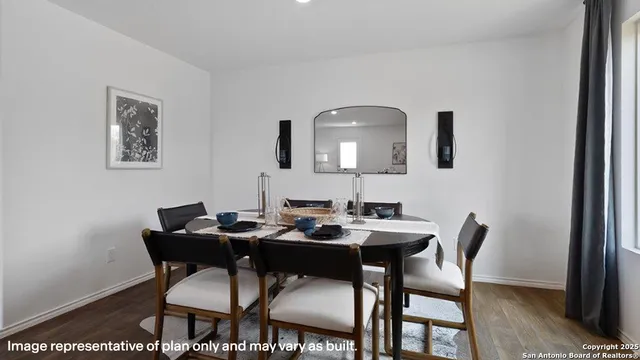 a dining room with furniture and wooden floor