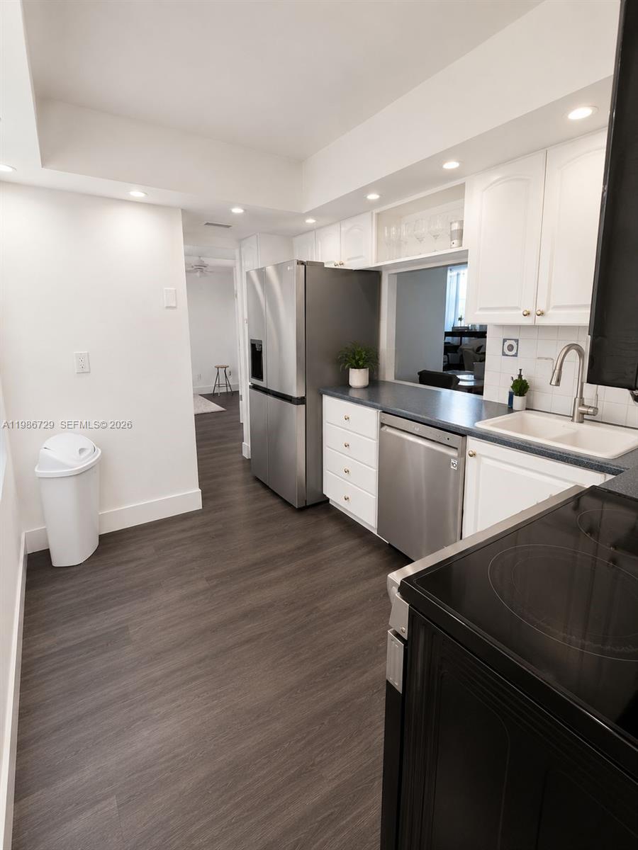 299 Northwest 52nd Terrace, Unit PHX Boca Raton, FL 33487 - Photo 6 of 16 a kitchen with a sink appliances and cabinets