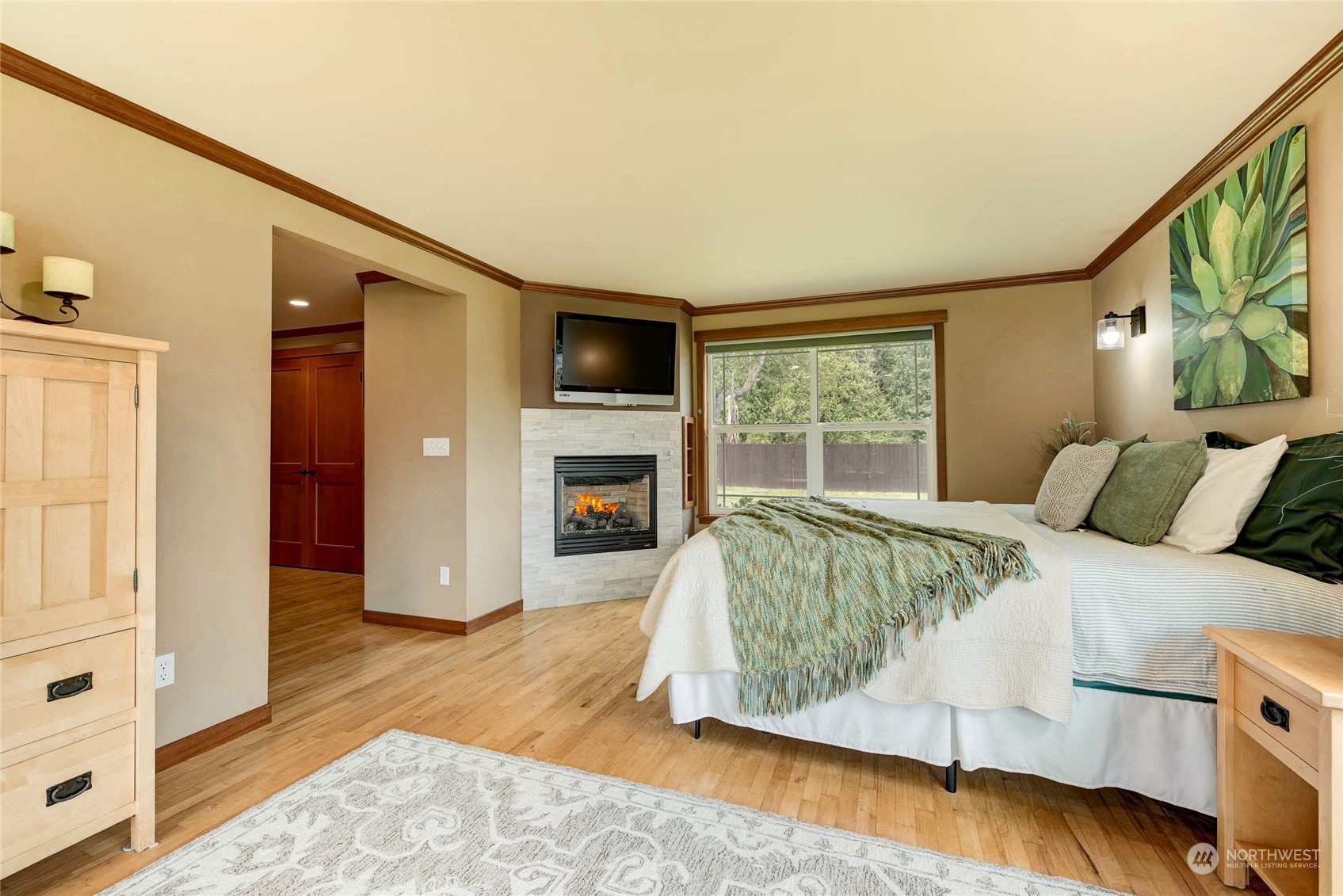 11821 Wagner Road Monroe, WA 98272 - Photo 23 of 40 a spacious bedroom with a bed and a flat screen tv