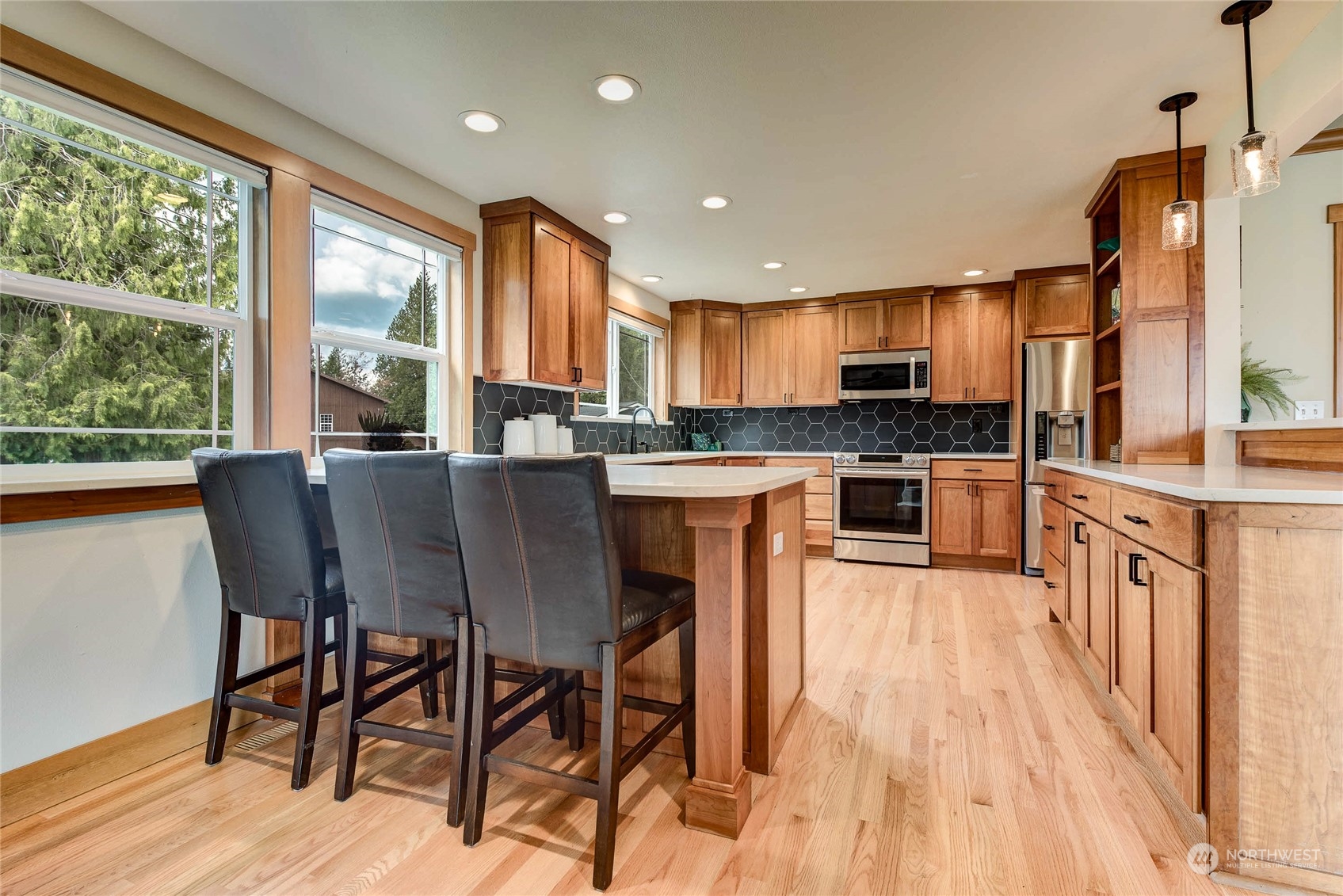 11821 Wagner Road Monroe, WA 98272 - Photo 33 of 40 a kitchen with stainless steel appliances granite countertop wooden floor dining table and chairs