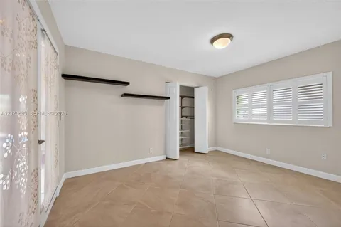 an empty room with closet and a shower
