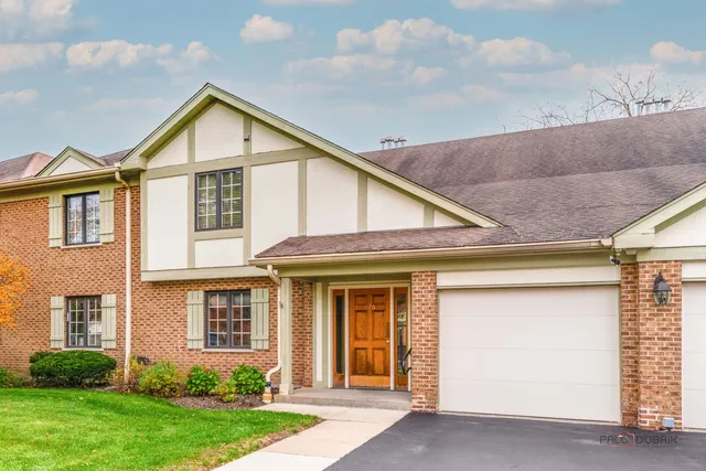 a view of a white house next to a yard