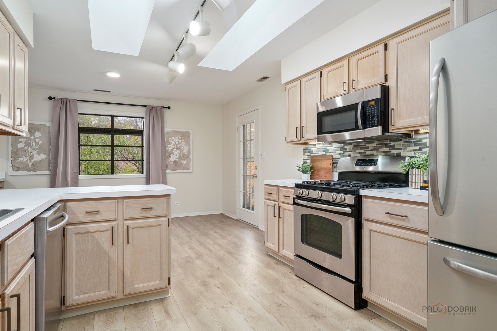 970 Ivy Lane, Unit C Deerfield, IL 60015 - Photo 15 of 36 a kitchen with stainless steel appliances granite countertop a stove a sink and a microwave