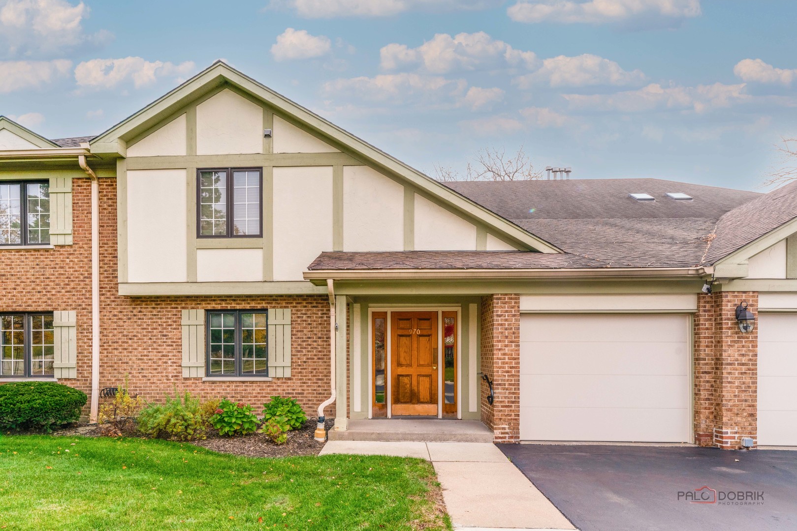 970 Ivy Lane, Unit C Deerfield, IL 60015 - Photo 2 of 36 a view of a house with brick walls and a yard with potted plants