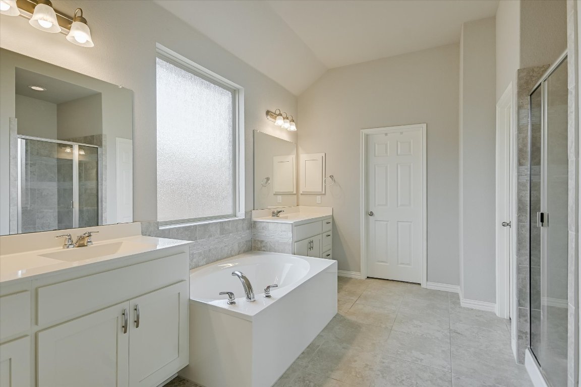 921 Isaias Drive Leander, TX 78641 - Photo 10 of 21 a bathroom with a sink a tub and a mirror