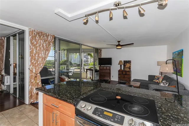 a kitchen with stainless steel appliances granite countertop a stove and cabinets